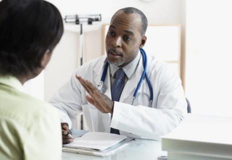 male doctor speaking to female patient