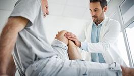 man having knee examined